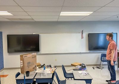 man working on classroom technology installation